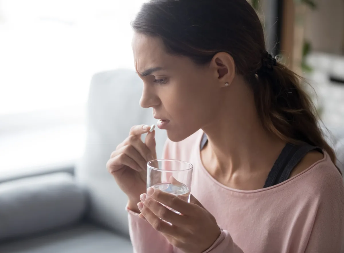 An image of a past female vybe urgent care patient taking antibiotics.