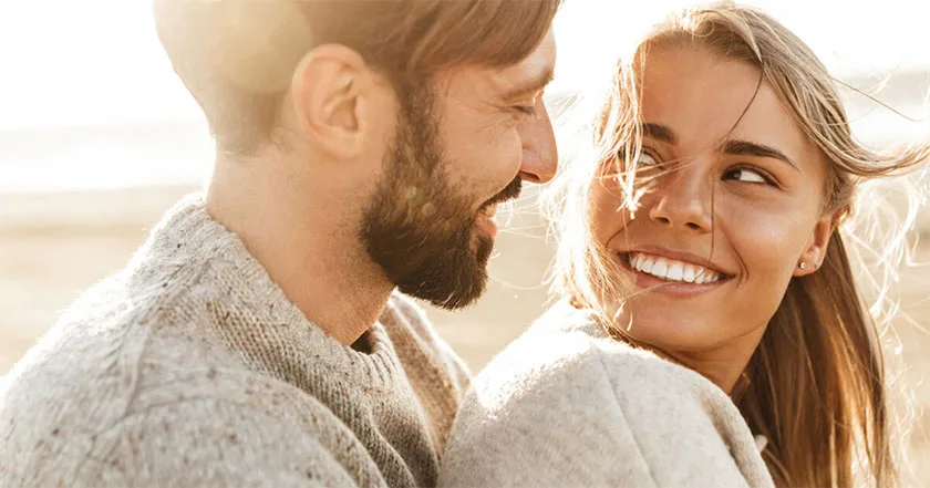 An enlarged image of a couple embracing one another outdoors.