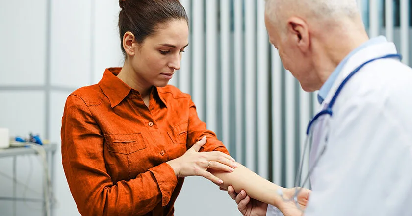 A wide-angle image of a vybe urgent care doctor performing a PPD test on a patient.