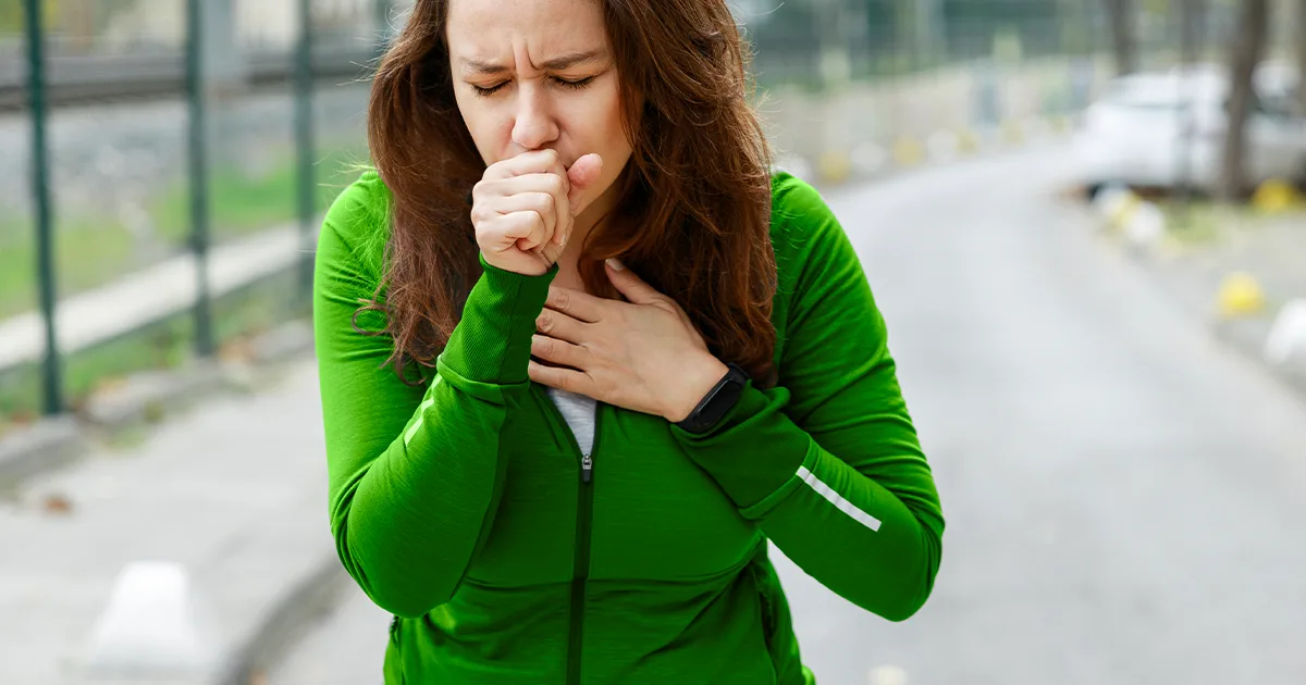 An image of a future vybe urgent care female patient coughing while on her run.