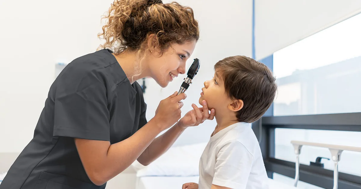An enlarged image of a vybe urgent care doctor checking a child for signs of a concussion.